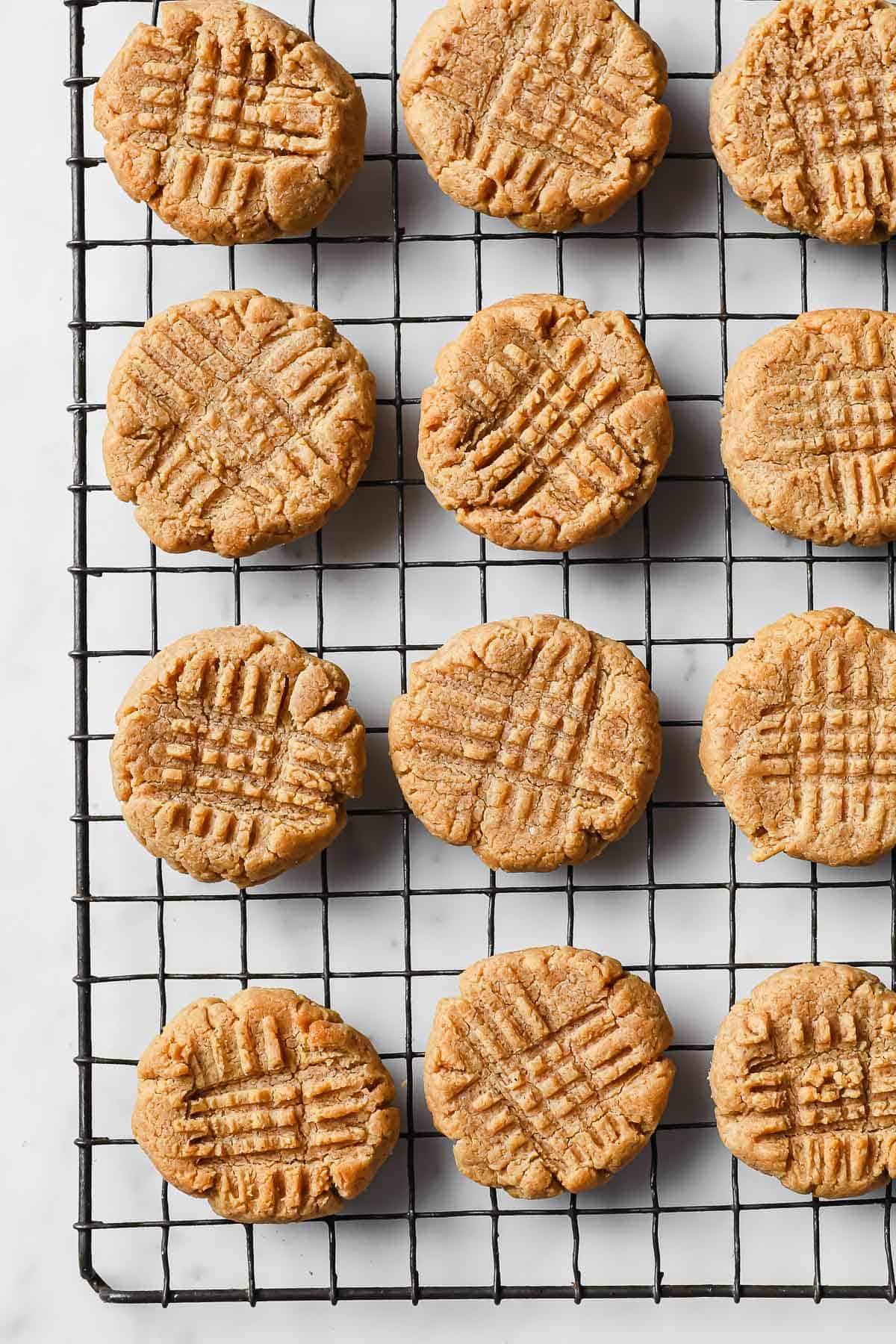 a wire cooling rack with low carb peanut butter cookies on it 