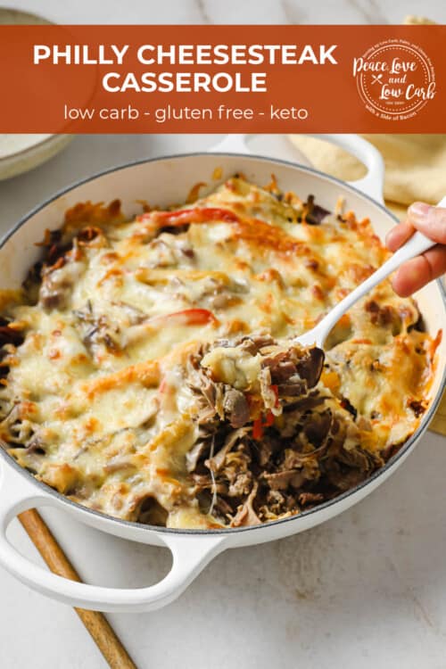 a cast iron skillet full of a casserole with meat, cheese, and vegetables.