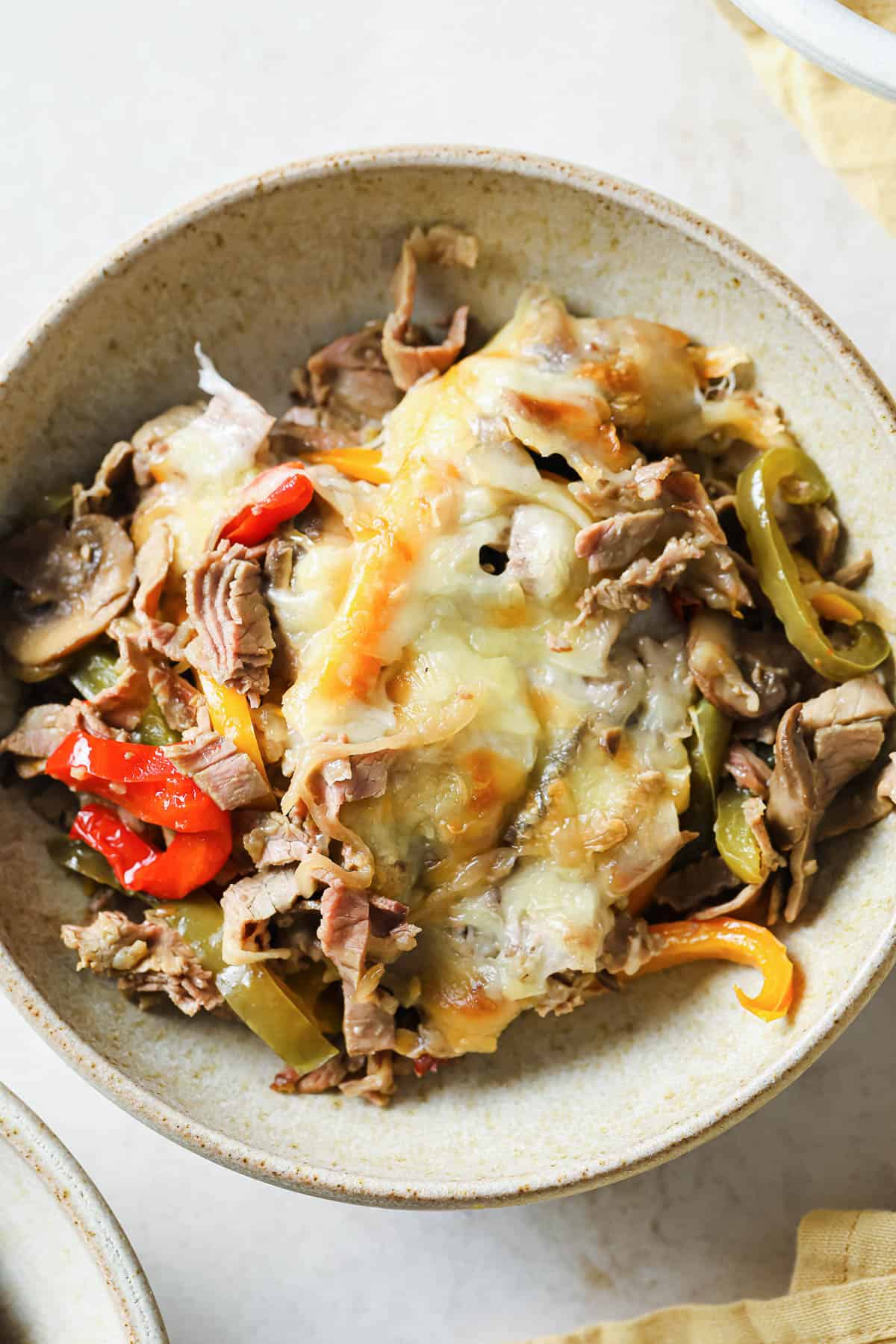 a bowl of Philly cheesesteak - peppers, onions, mushrooms, garlic, cheese
