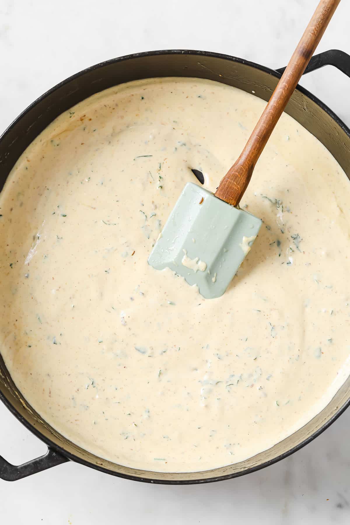 a cast iron skillet with a rich creamy base for gravy cooking.