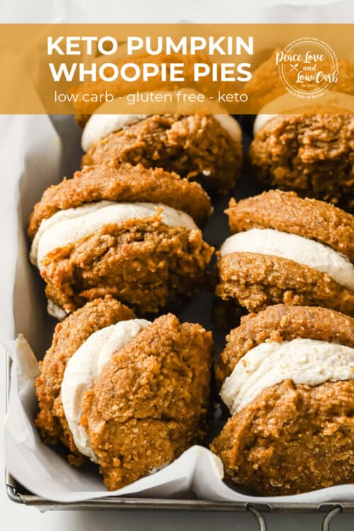 a dish lined with parchment paper and filled with pumpkin spice whoopie pies filled with cream cheese frosting.