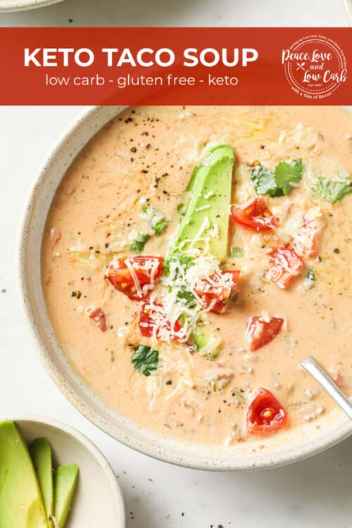 A bowl of creamy taco soup made with ground beef, onion, garlic, cream cheese, beef stock, diced tomatoes and green chilies. Garnished with avocado, tomato, cheese, and cilantro.